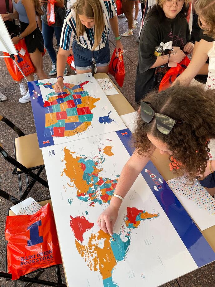 students working with a map of the world